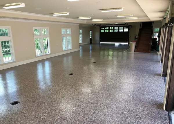 Large garage with glossy tan flake epoxy floor